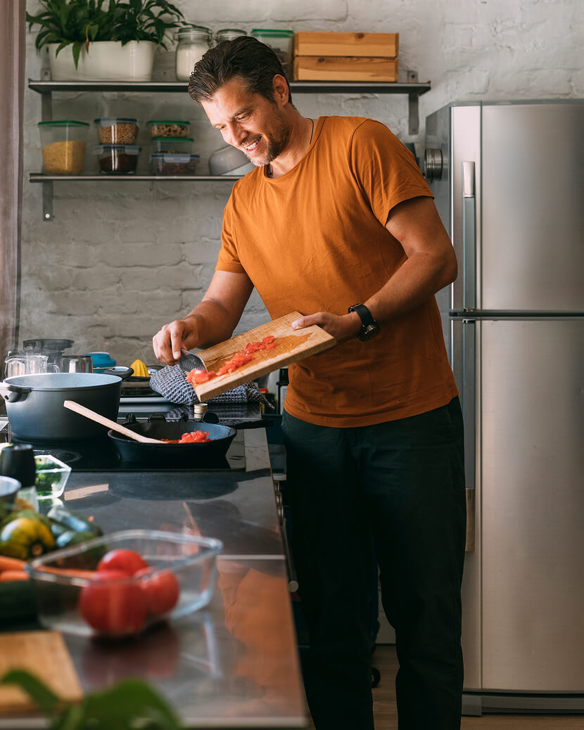 Image of a man scraping food into a plate