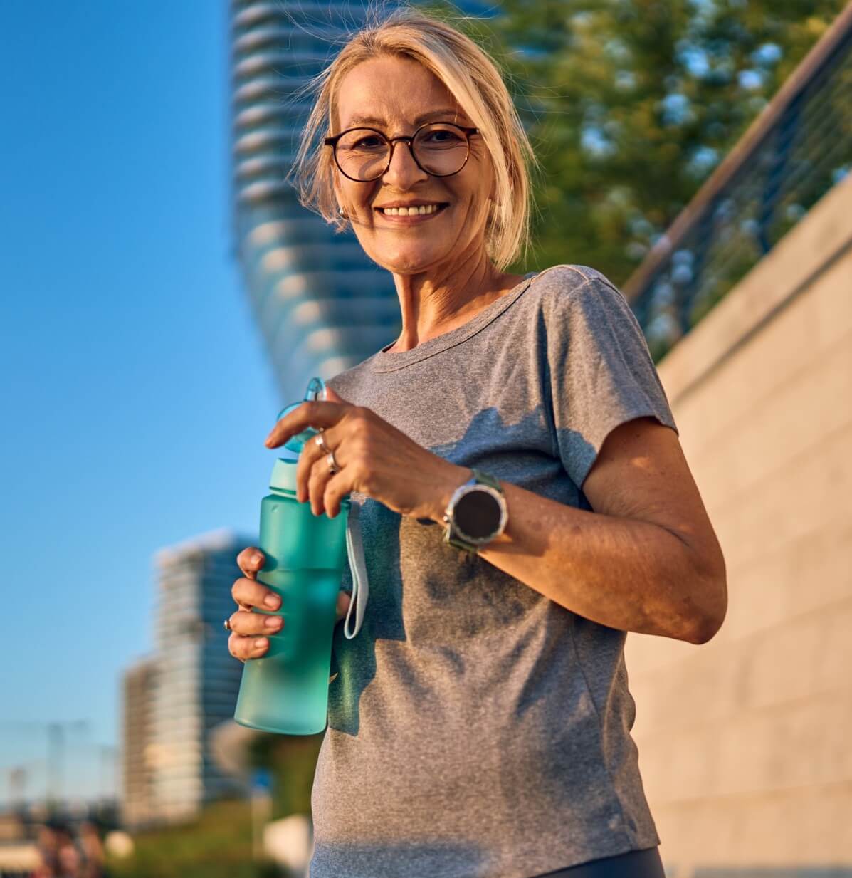 Image of woman outside holding a reusable bottle