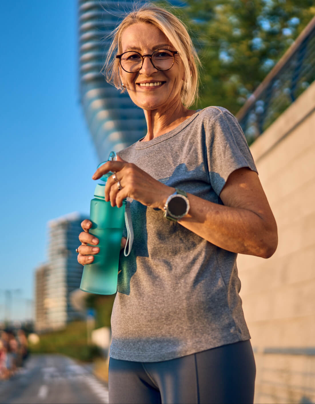 Image of woman outside holding a reusable bottle